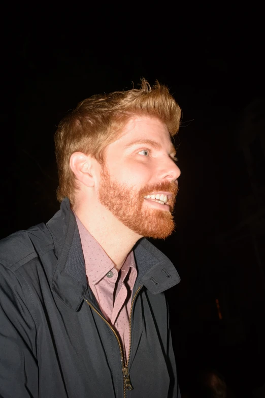 man with ginger hair wearing a shirt and tie