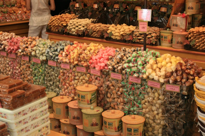 many pots of food with price signs on them