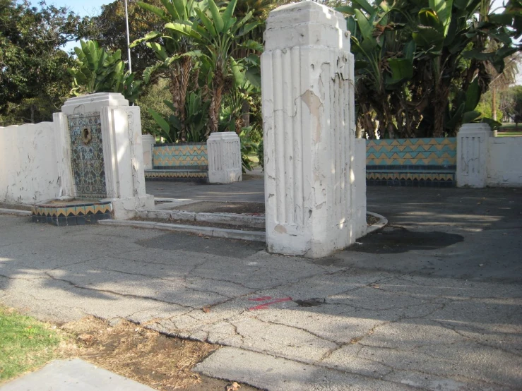 some cement pillars on the ground with plants