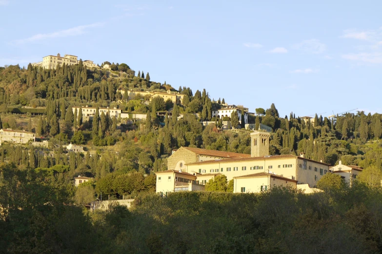 a city with many hills and trees behind it