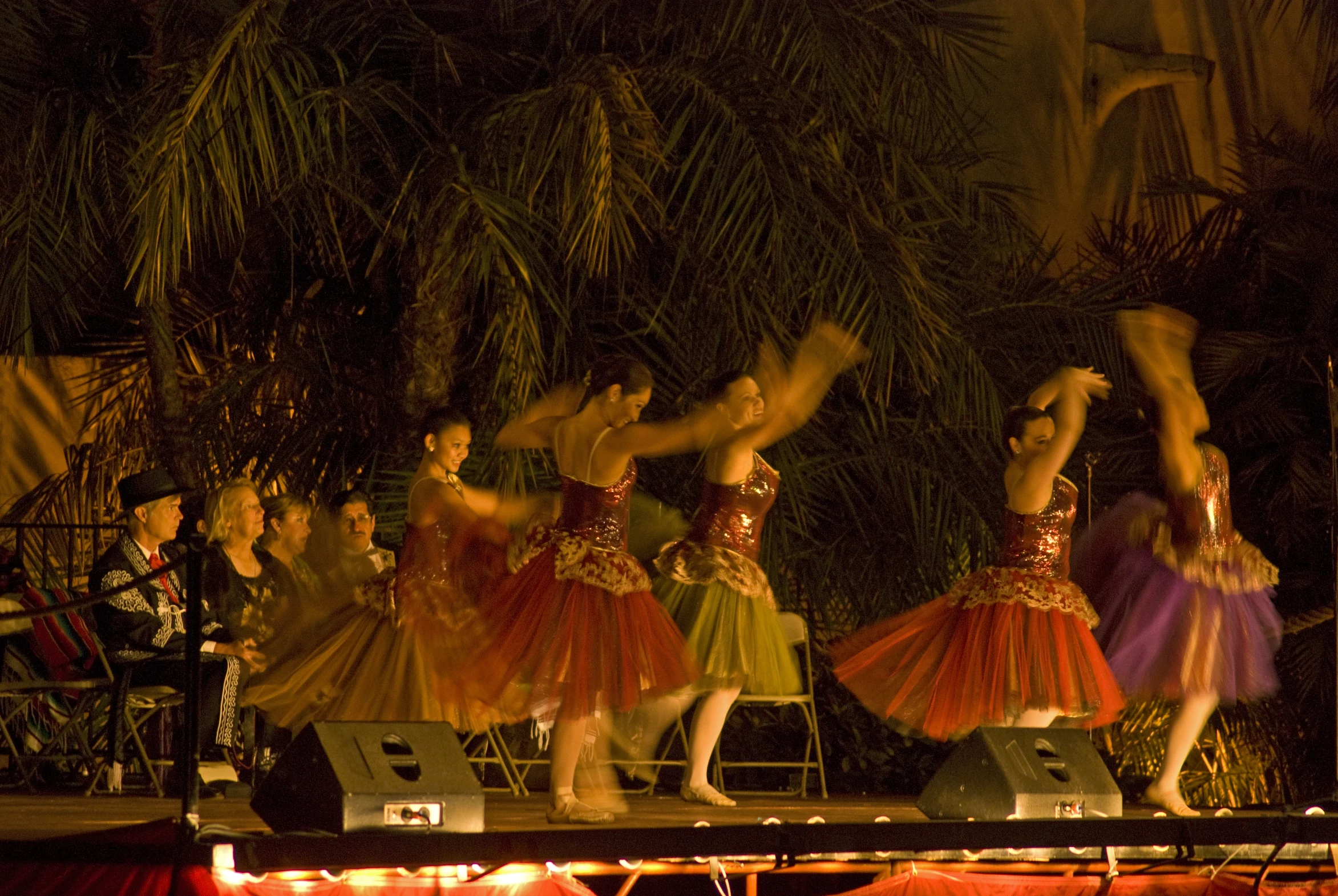 a number of people on a stage with their hands up