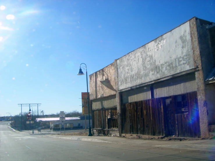 a rundown looking street with a building on the right