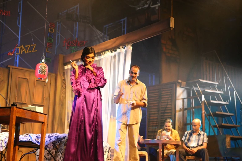 a woman standing next to a man on stage