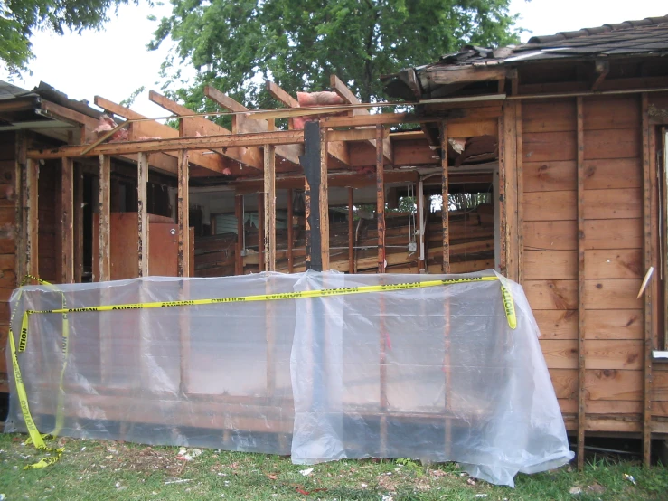 a house being built under construction with a sheet covering the whole structure