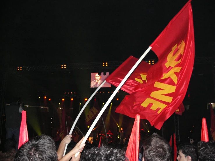 a man waving an american and chinese flag