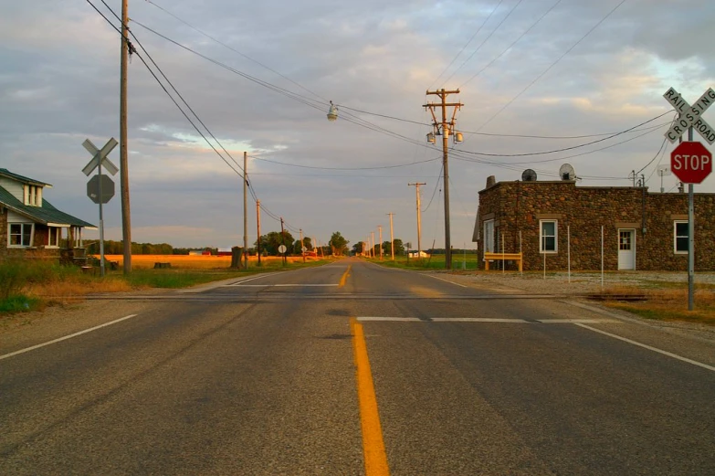 an empty road that is next to houses