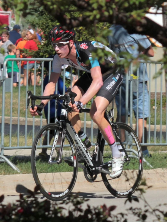 a bicyclist turning while another cyclist sits in the distance