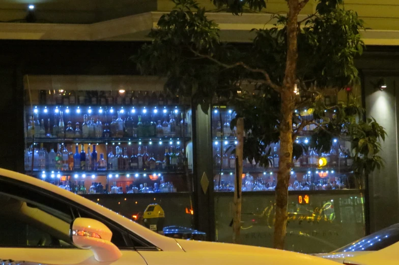 a taxi and several cars at night in the parking lot