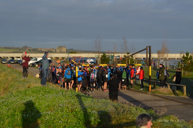 a large group of people are gathered at a sports park