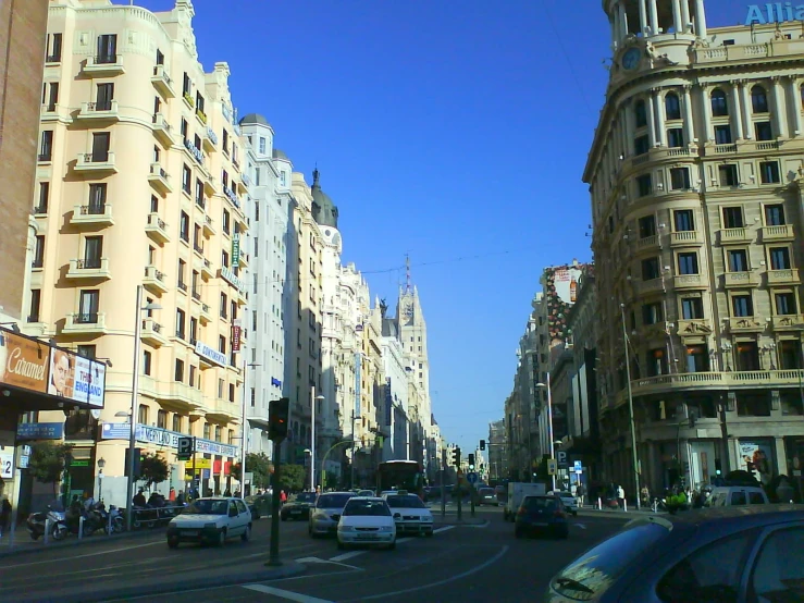 city street with cars and buildings with blue sky