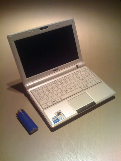 a white laptop and a lighter on a table