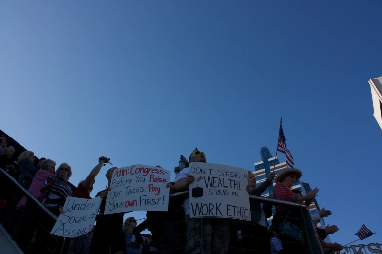 a group of people with protest signs on a ramp