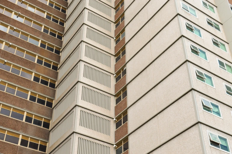 the windows of two buildings, one is blue and the other is brown