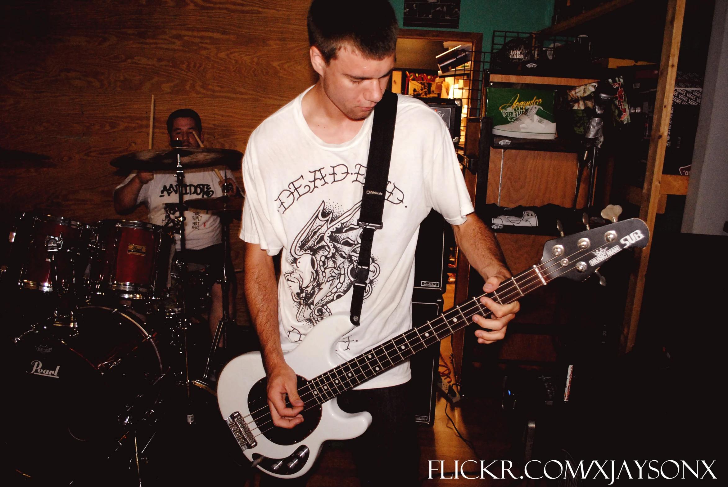 a person playing guitar in a room