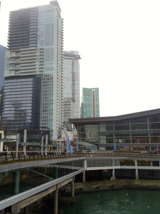 a couple of buildings next to water and a train