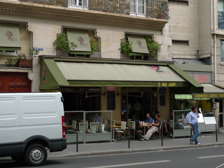 a city street scene with a cafe on the corner