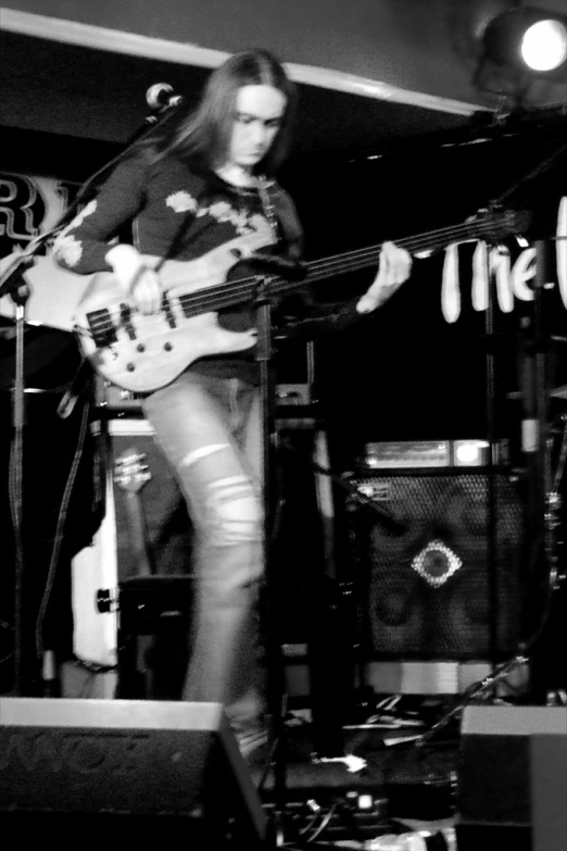 a woman in tight shorts playing on a guitar
