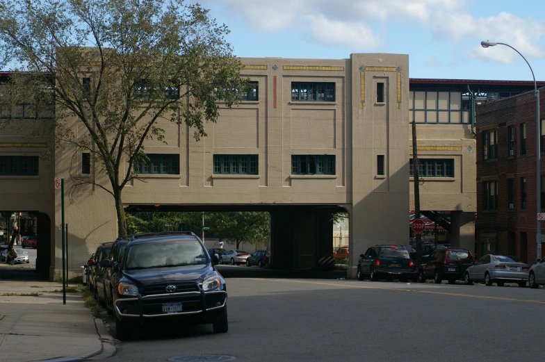 an older building is under a bridge over the street