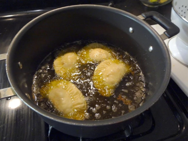 bananas sitting inside of a pan with brown liquid on the bottom of it