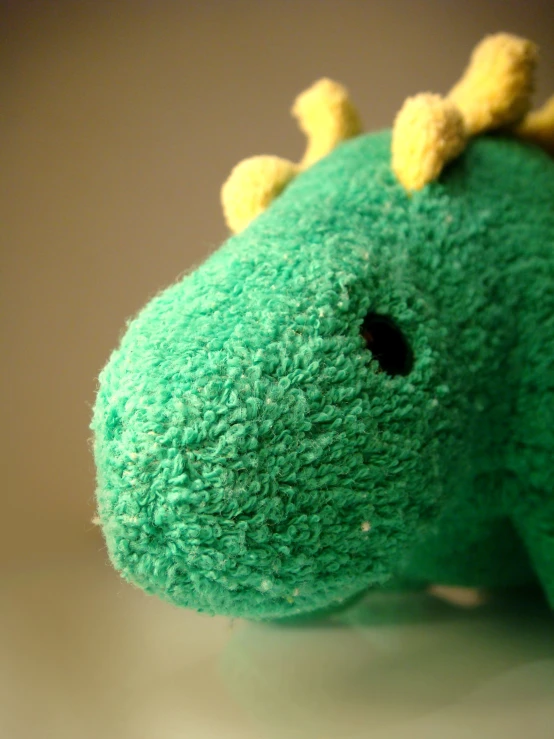 closeup of a green toy that looks like a dragon