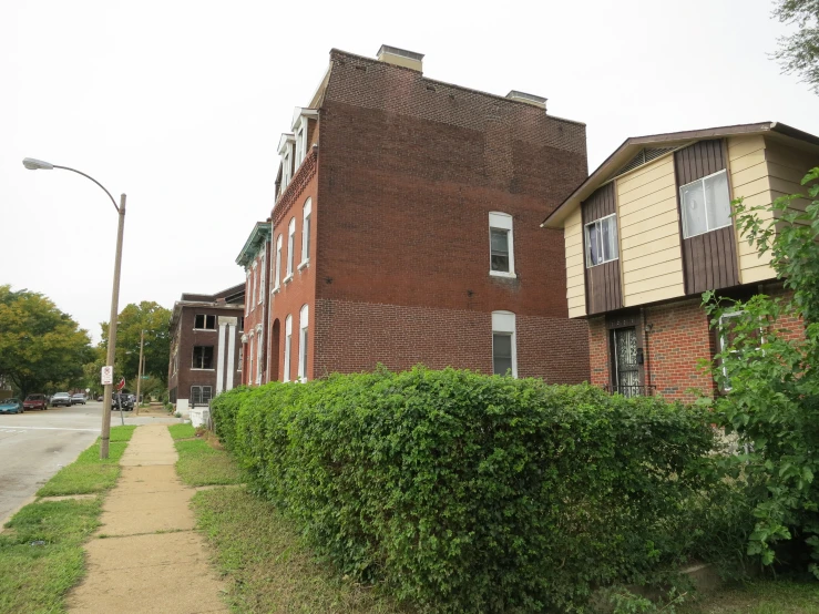 a street is lined with residential houses on a side walk