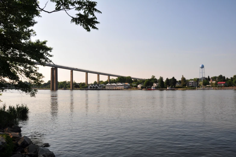 a bridge over a lake with buildings in the background