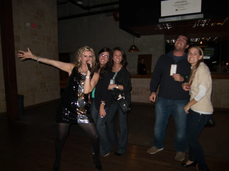 a group of people standing on top of a wooden floor