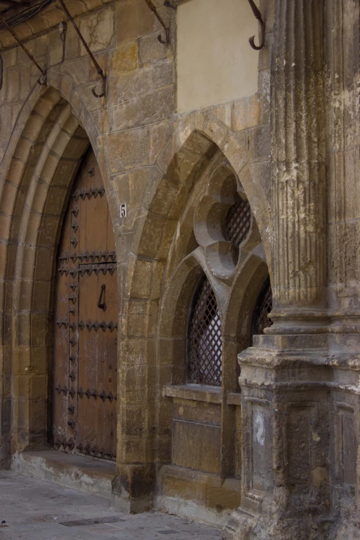 large, old door with a very intricate arch near it