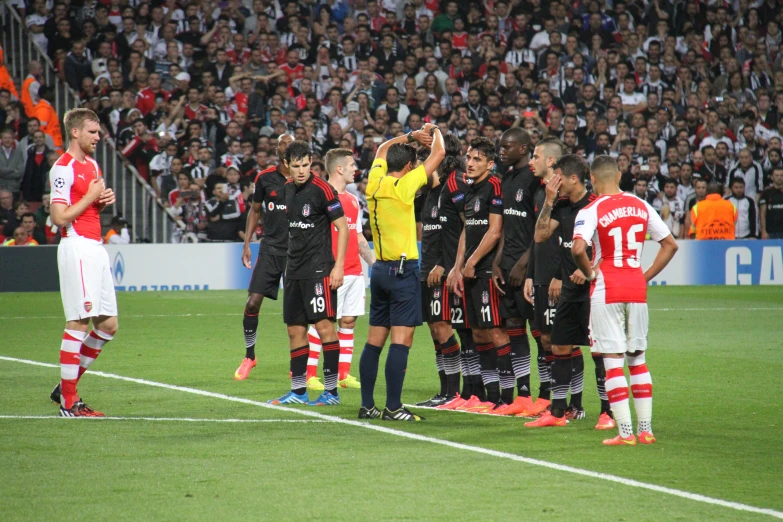 the referee is giving the boys instructions before the soccer game