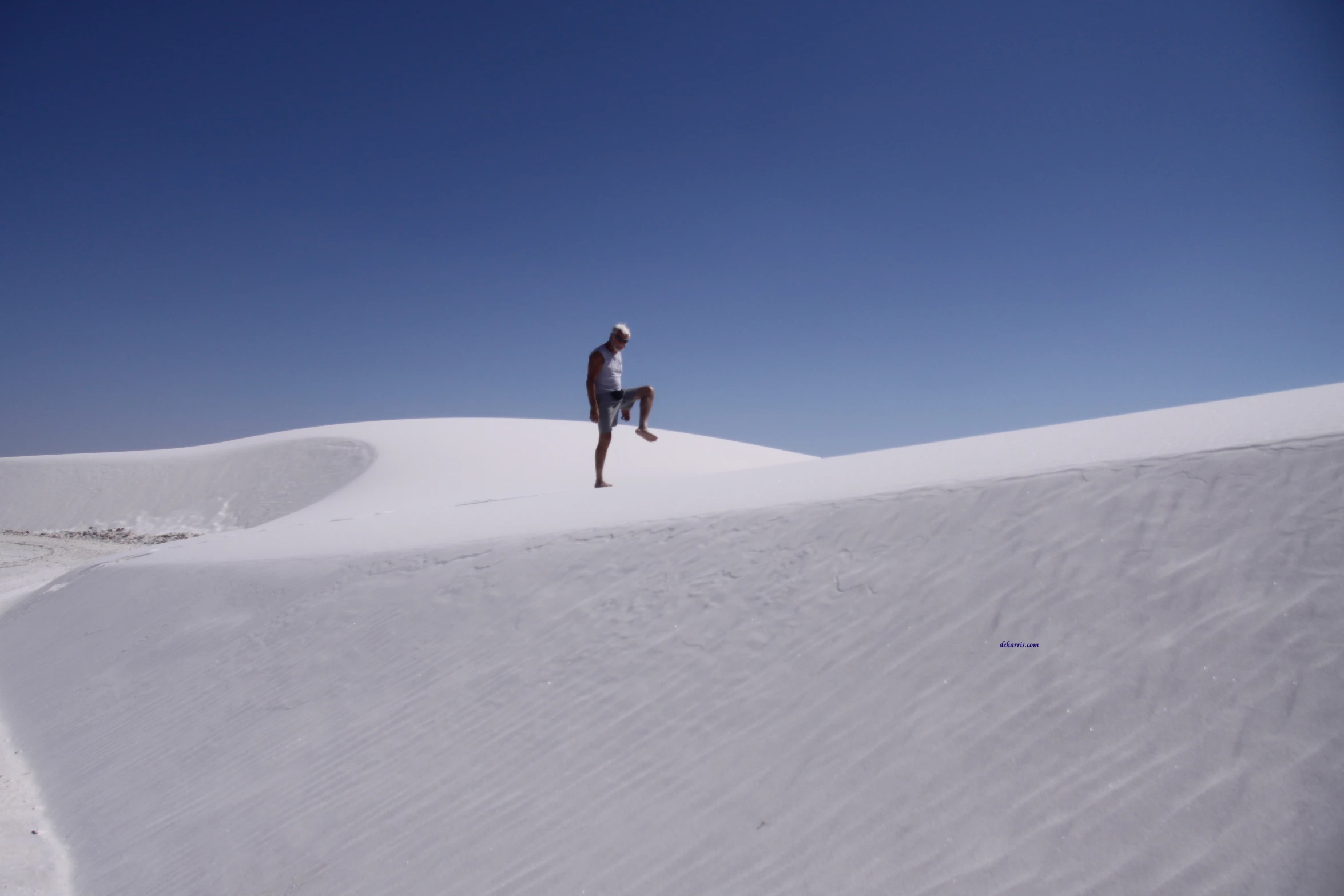 a man on top of a hill covered in snow