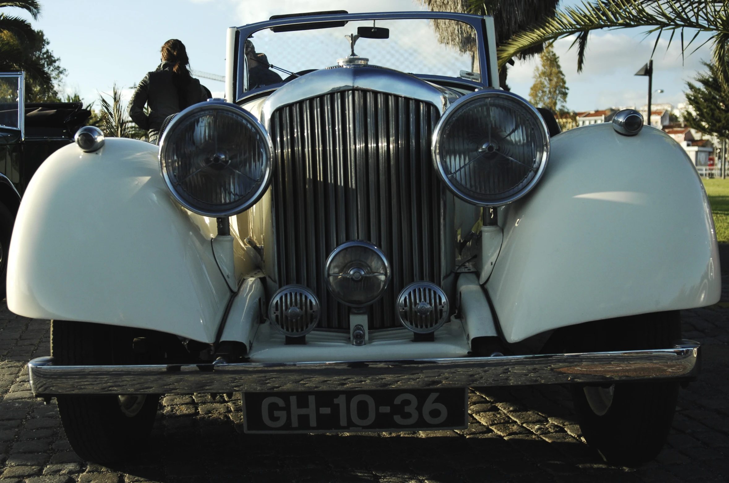 an old fashioned vintage car parked by some trees