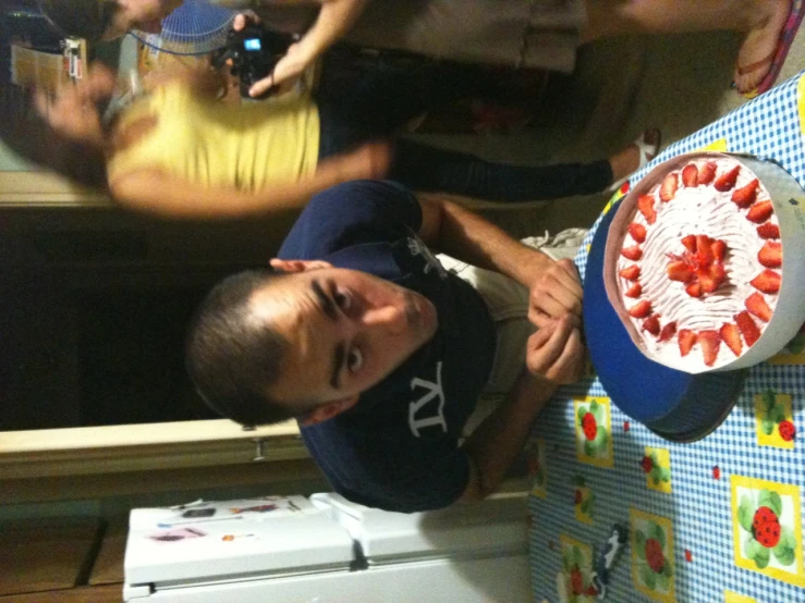 a young man is blowing out the candles on a cake