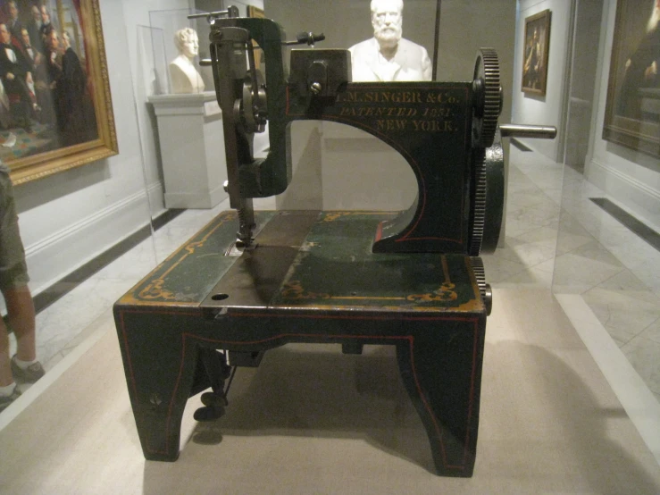 an old sewing machine on display in a museum