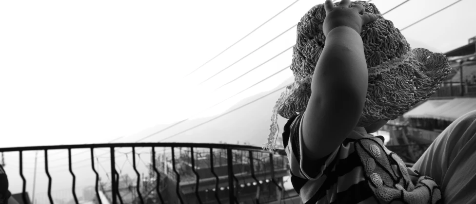 a person holding onto their hand near a fence