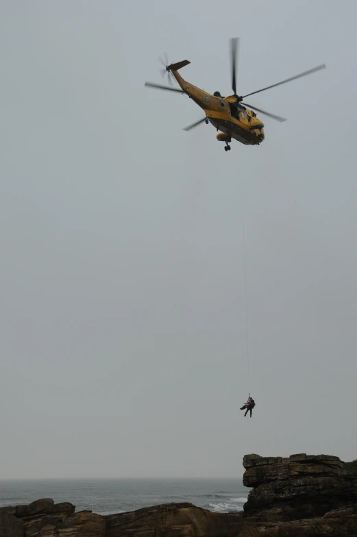 a helicopter that is flying over some rocks