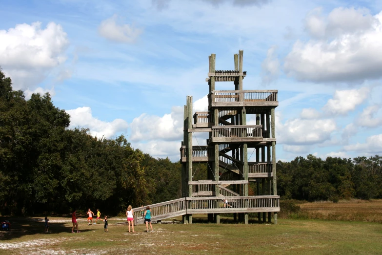 a wooden staircase is in the middle of a field