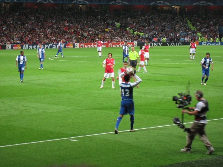 people in the middle of a soccer game holding catchers mitts