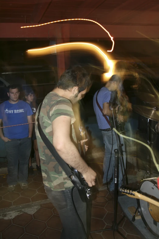 a man with a guitar playing on stage