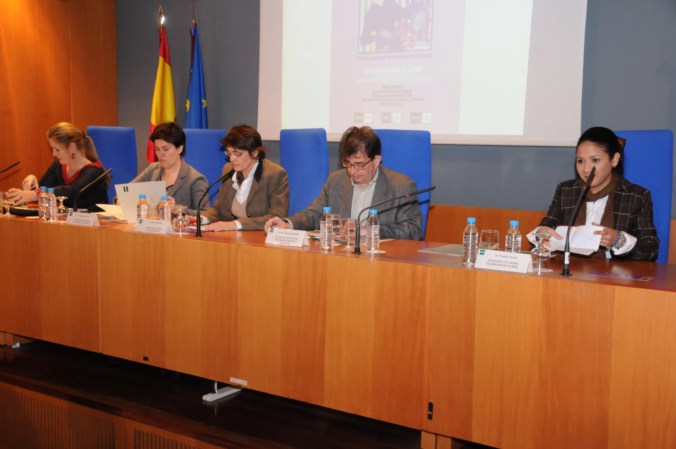 five people are sitting at a meeting table