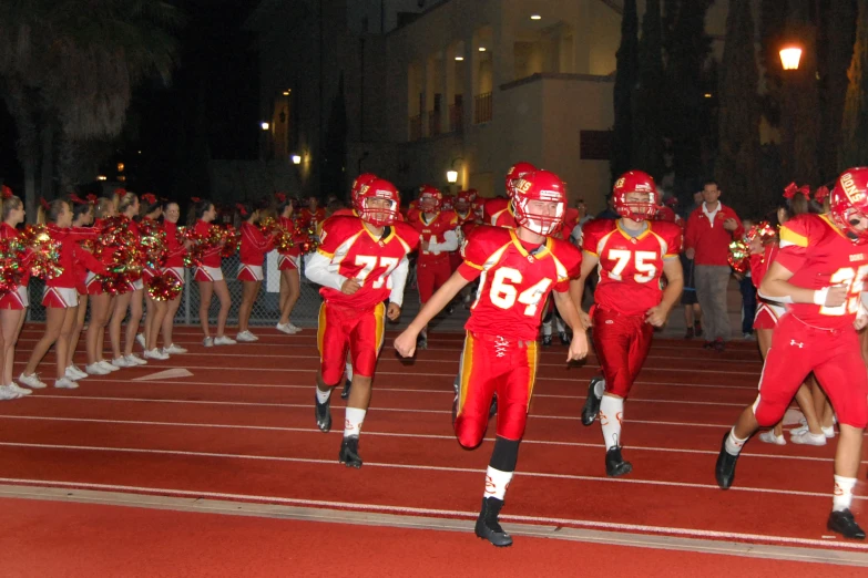 an image of two football players running on the field