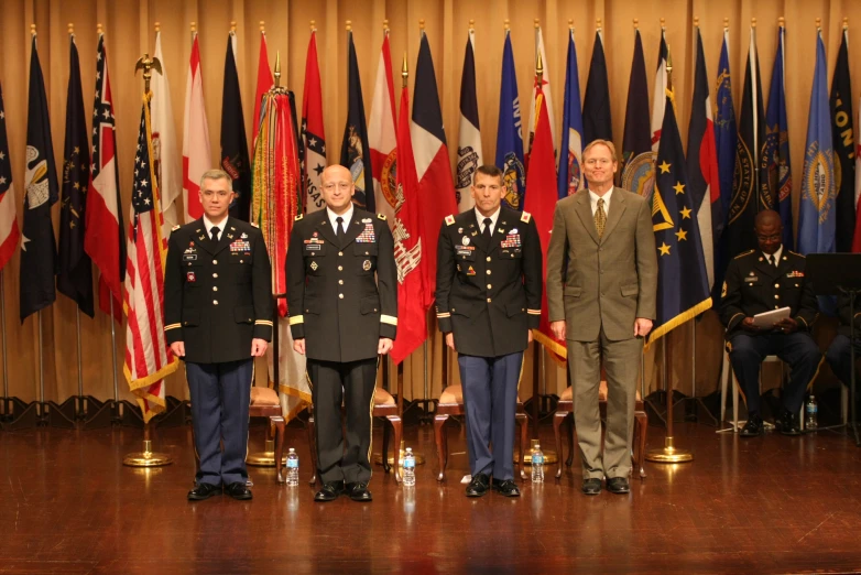 several men and women in uniforms standing on a stage