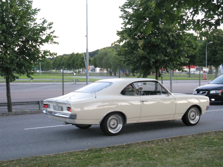 a classic car is stopped at an intersection