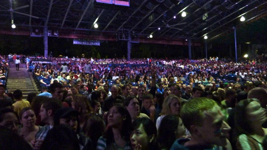 a large auditorium full of people and people in seats