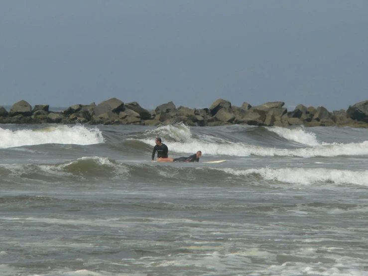 a person riding on top of a surfboard in the ocean