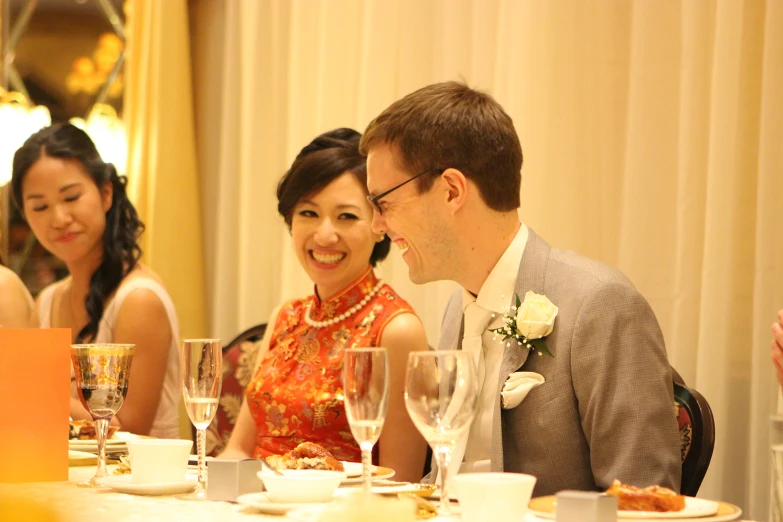 a man and woman sitting at a dinner table