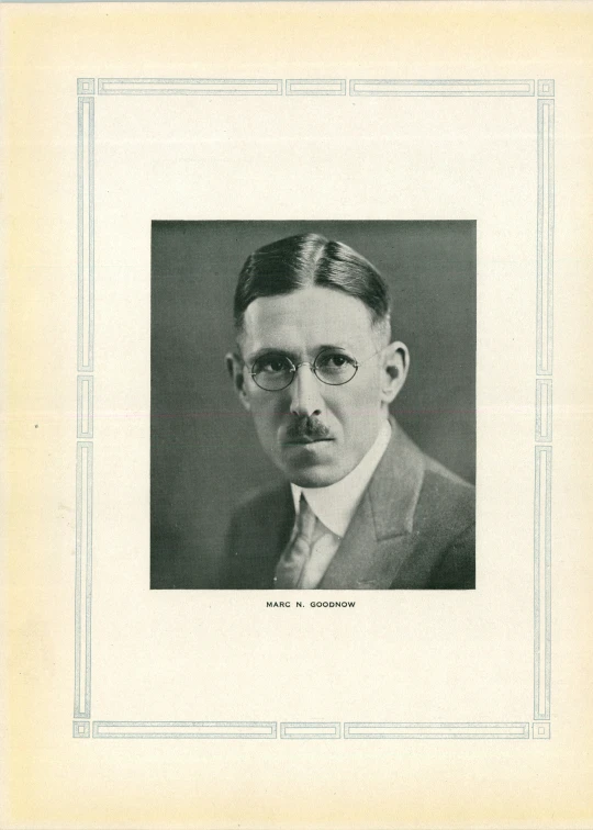 a pograph of a man with a mustache and glasses