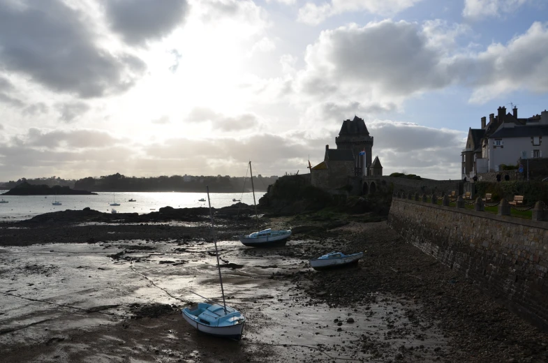 some boats in the water by a lighthouse