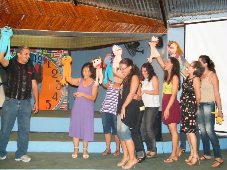 the group of people stand at the front of a stage