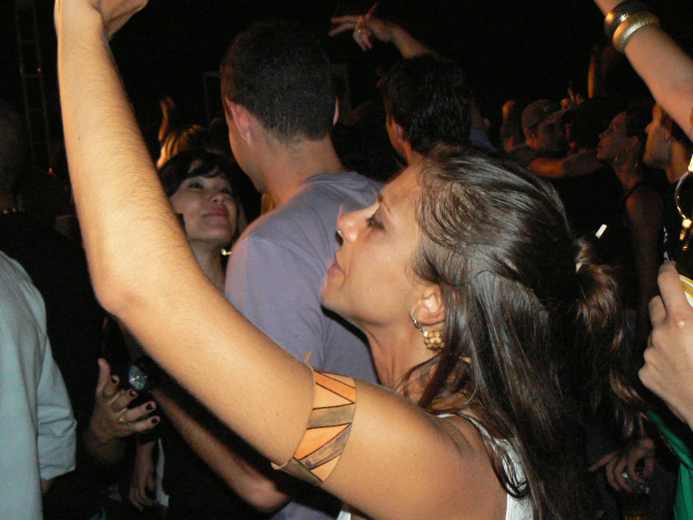 a woman standing next to a man while holding a glass