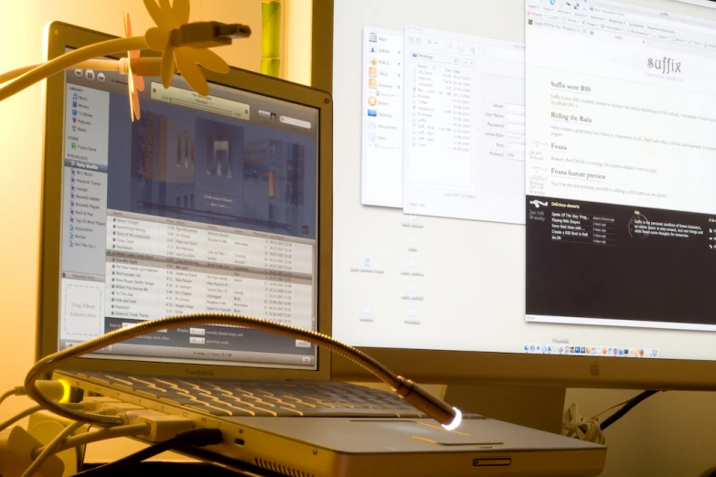 an open laptop computer sitting next to a large computer monitor